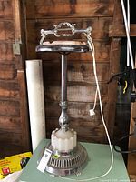 Full view of chrome ashtray stand showing cord and base