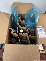 Open box showing assorted decorative bottles