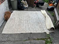 Full view of carpet laid out with underlay partially rolled