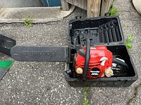Homelite 3816C chainsaw in open black carrying case with blade cover attached
