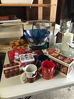All items grouped on table showing bowl, tins and mugs