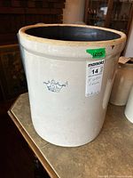 Full view of beige crock showing crown emblem and size label