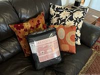 All three cushions displayed on sofa with packaged Maxijin cover
