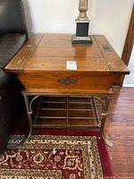 Overall view of side table between sofa and rug