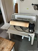 Front view showing roller, cabinet, control box, side shelf