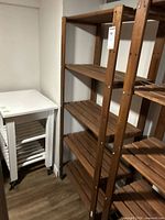 Full view of wooden shelving unit next to similar unit