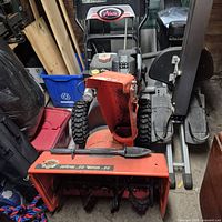 Front view showing Ariens branding, auger housing, tires, overall wear