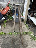 Full view of tripod standing on pavement