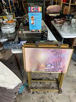 Overall lot view showing toaster oven, table cover, TV tray set, stand