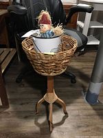 Full view of plant stand with bucket and scarecrow