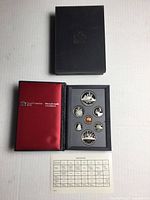 Outer sleeve, open folio with coins and spec card