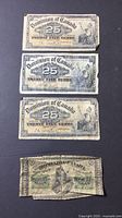 Four Dominion of Canada 25-cent notes front faces