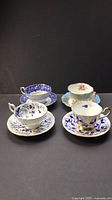 Group shot of four cup and saucer sets