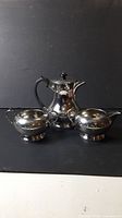 Full view of three-piece silverplate set: teapot, creamer, sugar bowl