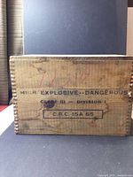 Side of crate showing High Explosive—Dangerous stencil with dovetail joints