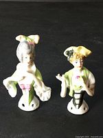 Front view of both porcelain half dolls standing upright