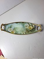 Full top view of the tray showing floral design and handles