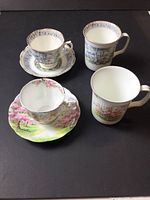 Group view of two teacups with saucers and two mugs