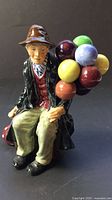 Front view of Royal Doulton The Balloon Man figurine showing face, outfit and balloons