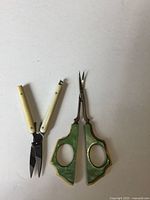 Both scissors laid flat showing overall design and size comparison