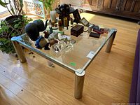 Full view of square glass coffee table with chrome legs