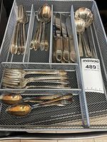 Full view of flatware pieces arranged in mesh tray