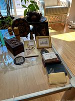 Overall view of lot items on glass table