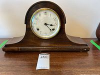 Front view of wooden tambour mantel clock showing dial and case