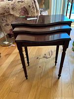 Front view of three nesting tables stacked