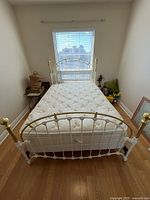 Full view of assembled bed showing headboard, footboard, mattress and box spring