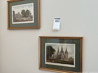 Both framed prints hanging on wall