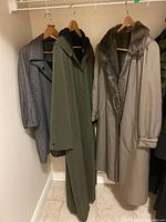 Three coats hanging in closet