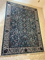 Full view of the Persian-style area rug showing overall pattern and fringe