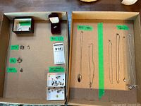 Overview of entire lot showing chains, ring, pendants, studs in sorted compartments