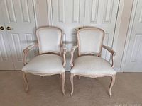 Front view of both matching Louis XV style armchairs