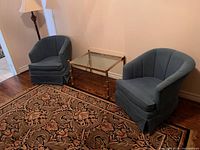 Both blue upholstered tub chairs side by side showing overall design and colour