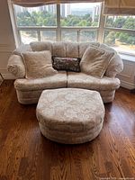 Front view of upholstered sofa with matching ottoman