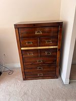 Front view of dresser showing drawer layout and brass hardware