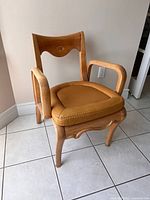 Front three-quarter view of wooden armchair