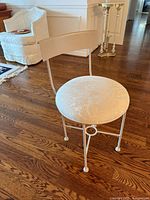 front angle of stool showing seat upholstery and frame