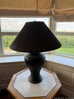 Full view of lamp on table showing shade and body