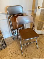 Two chairs folded together and one opened, showing overall design and quantity