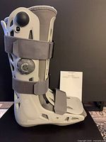 Left-side view of Aircast AirSelect Standard walking boot showing inflation dial, straps, liner and manual