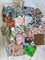 Overview of all sealed decorative napkin packs spread on bed