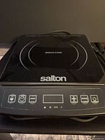 Top view showing Salton induction cooktop, control panel with touch buttons and display