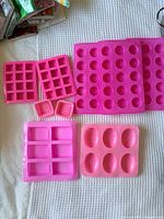 All seven pink silicone molds displayed on white surface