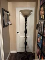 Full view of the torchiere floor lamp against wall