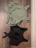 Two swim tops laid flat showing color and style