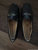 Top view of both loafers showing size marking and metal detail
