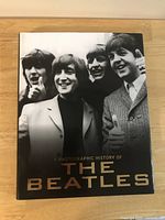 Front cover with dust jacket showing title and group image